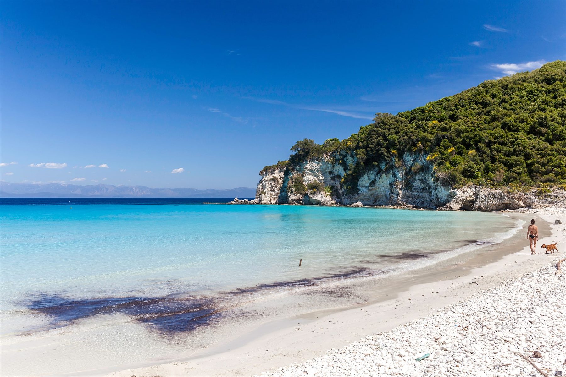 Voutoumi beach on Antipaxos, white pebbles meeting bright turquoise shallows
